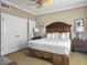 Cozy bedroom featuring a king-sized bed, soft lighting, and ample closet space at 5802 Palmetto Dr # B-202, Isle of Palms, SC 29451