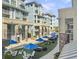 Beautiful view of community gathering space with lounging chairs, umbrellas, and lush astroturf at 5802 Palmetto Dr # B-202, Isle of Palms, SC 29451