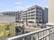 Stunning view of exterior buildings and shops from a private balcony at 5802 Palmetto Dr # B-202, Isle of Palms, SC 29451