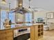 Updated kitchen with stainless hood, adjacent seating area, and an open concept living space at 5802 Palmetto Dr # B-202, Isle of Palms, SC 29451