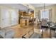 Open-concept living space with kitchen island, seating, and dining area with neutral tones and stylish decor at 5802 Palmetto Dr # B-202, Isle of Palms, SC 29451