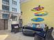 Well decorated outdoor seating and lounge space with surf board decor at 5802 Palmetto Dr # B-202, Isle of Palms, SC 29451