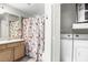 Full bathroom featuring a vanity, laundry area, and a shower with a curtain at 700 Daniel Ellis Dr # 14206, Charleston, SC 29412