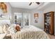 Comfortable bedroom with door to the patio, a ceiling fan, and a full bookcase at 700 Daniel Ellis Dr # 14206, Charleston, SC 29412