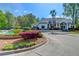Clubhouse exterior with fountain, beautiful landscaping, and paved parking area at 700 Daniel Ellis Dr # 14206, Charleston, SC 29412
