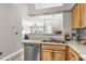 Well-lit kitchen featuring stainless steel appliances and a view into the bright living area at 700 Daniel Ellis Dr # 14206, Charleston, SC 29412