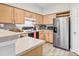 Functional kitchen with stainless steel refrigerator and light wood cabinets at 700 Daniel Ellis Dr # 14206, Charleston, SC 29412