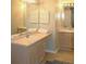 Well-lit bathroom featuring a large mirror, double sinks, and cabinet storage at 700 Daniel Ellis Dr # 6107, Charleston, SC 29412