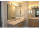 Well-lit bathroom featuring a large mirror, double sinks, and cabinet storage at 700 Daniel Ellis Dr # 6107, Charleston, SC 29412