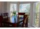 Bright dining area features dark wood table set and windows offering views at 700 Daniel Ellis Dr # 6107, Charleston, SC 29412