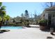 Swimming pool and patio area with trees and lounge chairs on a sunny day at 700 Daniel Ellis Dr # 6107, Charleston, SC 29412