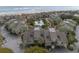 An aerial view of condos near the beach, featuring a shared pool, parking, and ocean views at 7000 Palmetto Dr # 5A, Isle of Palms, SC 29451