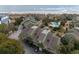 Aerial view of beachfront condo complex with a pool, lush landscaping, and parking near the ocean at 7000 Palmetto Dr # 5A, Isle of Palms, SC 29451