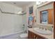Stylish bathroom with a bathtub and shower combo, vanity, and decorative mirror and artwork at 7000 Palmetto Dr # 5A, Isle of Palms, SC 29451
