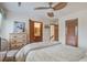 Inviting bedroom with a ceiling fan, light-colored furniture, and access to a bathroom and hall at 7000 Palmetto Dr # 5A, Isle of Palms, SC 29451