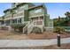Exterior of the condo unit with a private deck, outdoor stairs, and well-maintained grounds at 7000 Palmetto Dr # 5A, Isle of Palms, SC 29451