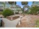 Beautifully landscaped view of the condos with palm trees and scenic walkways at 7000 Palmetto Dr # 5A, Isle of Palms, SC 29451
