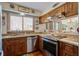 Charming kitchen featuring wood cabinets, stainless steel appliances, and granite countertops at 7000 Palmetto Dr # 5A, Isle of Palms, SC 29451