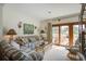 Comfortable living room with sofas, wicker furniture, and sliding doors to the deck with outdoor seating at 7000 Palmetto Dr # 5A, Isle of Palms, SC 29451