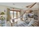 Relaxing living room with deck access, wicker furniture, and nautical decor for a beachy vibe at 7000 Palmetto Dr # 5A, Isle of Palms, SC 29451