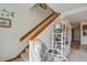 Stairway with decorative shelving and ocean decor near kitchen and other living spaces at 7000 Palmetto Dr # 5A, Isle of Palms, SC 29451