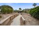 Pathway with wood retaining walls leading through the condo community at 7000 Palmetto Dr # 5A, Isle of Palms, SC 29451