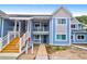 A bright blue condo building with stairs leading to the second floor and a sidewalk at 851 Sandlake Dr # F, Mount Pleasant, SC 29464
