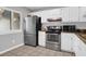 Kitchen with stainless steel appliances, white cabinets, and light gray countertops at 851 Sandlake Dr # F, Mount Pleasant, SC 29464
