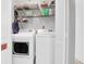 Convenient laundry room with full-sized washer and dryer units, and storage shelves above at 851 Sandlake Dr # F, Mount Pleasant, SC 29464
