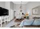 Bright living room featuring tile floors, neutral walls, plush sofa and unique light fixture at 851 Sandlake Dr # F, Mount Pleasant, SC 29464