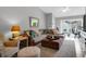 Inviting living room with large sofa, ottoman, fan, and desk that provides backyard view at 851 Sandlake Dr # F, Mount Pleasant, SC 29464