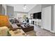 Comfortable living room with sofa, ottoman, television, and desk with backyard view at 851 Sandlake Dr # F, Mount Pleasant, SC 29464