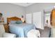 Main bedroom with light blue quilt, neutral walls, and vaulted ceiling at 851 Sandlake Dr # F, Mount Pleasant, SC 29464