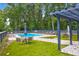 Community pool with lounge chairs, tables, and sun umbrellas perfect for relaxation by the pool at 851 Sandlake Dr # F, Mount Pleasant, SC 29464