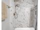 Close up of marble tile shower with bronze rainfall shower head and built in niche at 851 Sandlake Dr # F, Mount Pleasant, SC 29464
