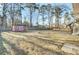 A spacious backyard featuring a storage shed and plenty of room for recreation surrounded by mature trees and fencing at 105 Alan Ct, Summerville, SC 29485