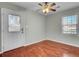 A sunny bedroom featuring hardwood floors and a modern ceiling fan with light fixtures, ideal for rest and relaxation at 105 Alan Ct, Summerville, SC 29485