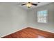 A clean, empty bedroom showcases hardwood floors, a ceiling fan, and a bright window at 105 Alan Ct, Summerville, SC 29485