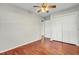 A cozy bedroom featuring hardwood floors, a ceiling fan and closet space, perfect for comfortable living at 105 Alan Ct, Summerville, SC 29485