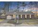 Charming brick home with an attached garage, a well-maintained lawn and a bright blue front door at 105 Alan Ct, Summerville, SC 29485