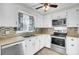 This kitchen features a double sink, stainless steel appliances and white cabinets at 105 Alan Ct, Summerville, SC 29485