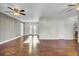 A spacious living room features wood floors, a ceiling fan, and a doorway that leads to the back patio at 105 Alan Ct, Summerville, SC 29485
