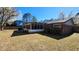 Backyard featuring a screened-in porch, brick facade, and lush greenery at 105 Ford Ct, Summerville, SC 29483