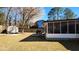 Expansive backyard with a shed, screened porch, mature trees, and wooden fence at 105 Ford Ct, Summerville, SC 29483