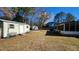 Spacious backyard featuring a shed, shade trees, and ample space for outdoor activities at 105 Ford Ct, Summerville, SC 29483