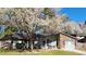 Charming single-story home featuring a brick facade, flowering tree, and well-maintained front yard at 105 Ford Ct, Summerville, SC 29483