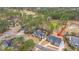 High-angle view of a house with mature trees, and a golf course in the background, ideal for golf enthusiasts at 105 Pine Valley Dr, Summerville, SC 29483