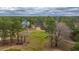 Aerial view showcasing the golf course, surrounding trees, and a glimpse of the neighborhood homes at 105 Pine Valley Dr, Summerville, SC 29483