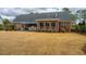 Serene backyard with brick home, spacious lawn and inviting patio area for relaxation and gatherings at 105 Pine Valley Dr, Summerville, SC 29483