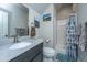 Well-lit bathroom features a modern vanity with a light gray countertop and shower with patterned curtain at 105 Pine Valley Dr, Summerville, SC 29483
